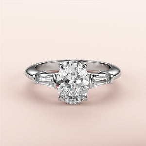 Stunning 14K white gold engagement ring featuring an oval diamond center and tapered baguette side stones, not worn on model.