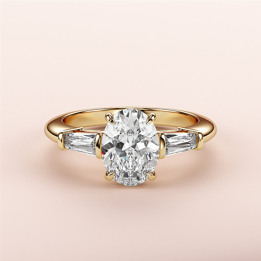 Elegant yellow gold engagement ring with an oval diamond and tapered baguettes, available in 14K, 18K, and platinum settings.|




#14KRecycledYellowGold
#18KRecycledYellowGold





