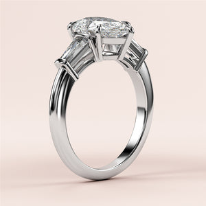 14K White Gold Butterfly Engagement Ring with Pear-Shaped Diamond and Trapezoid Cut Side Stones on Beige Background.