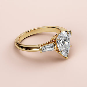 Elegant 14K gold engagement ring featuring a butterfly design, three-stone setting with tapered baguette diamonds.
