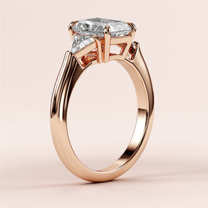 Rose Gold 14K radiant three-stone triangle engagement ring with elongated diamond shape setting, perfect for a timeless proposal.