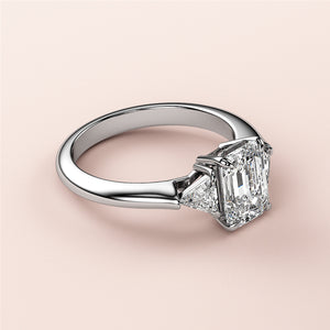 Elegant 14K or 18K white gold engagement ring featuring three emerald-cut stones in a stunning triangle setting.