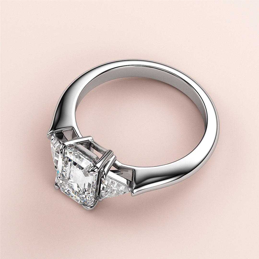Elegant 14K white gold engagement ring featuring an Asscher-cut diamond in a three-stone setting, perfect for love and commitment.