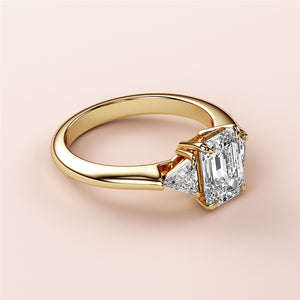 14K Gold Emerald Three-Stone Triangle Engagement Ring with Asscher-Cut Diamond and Trilliant Accents on Model's Hand