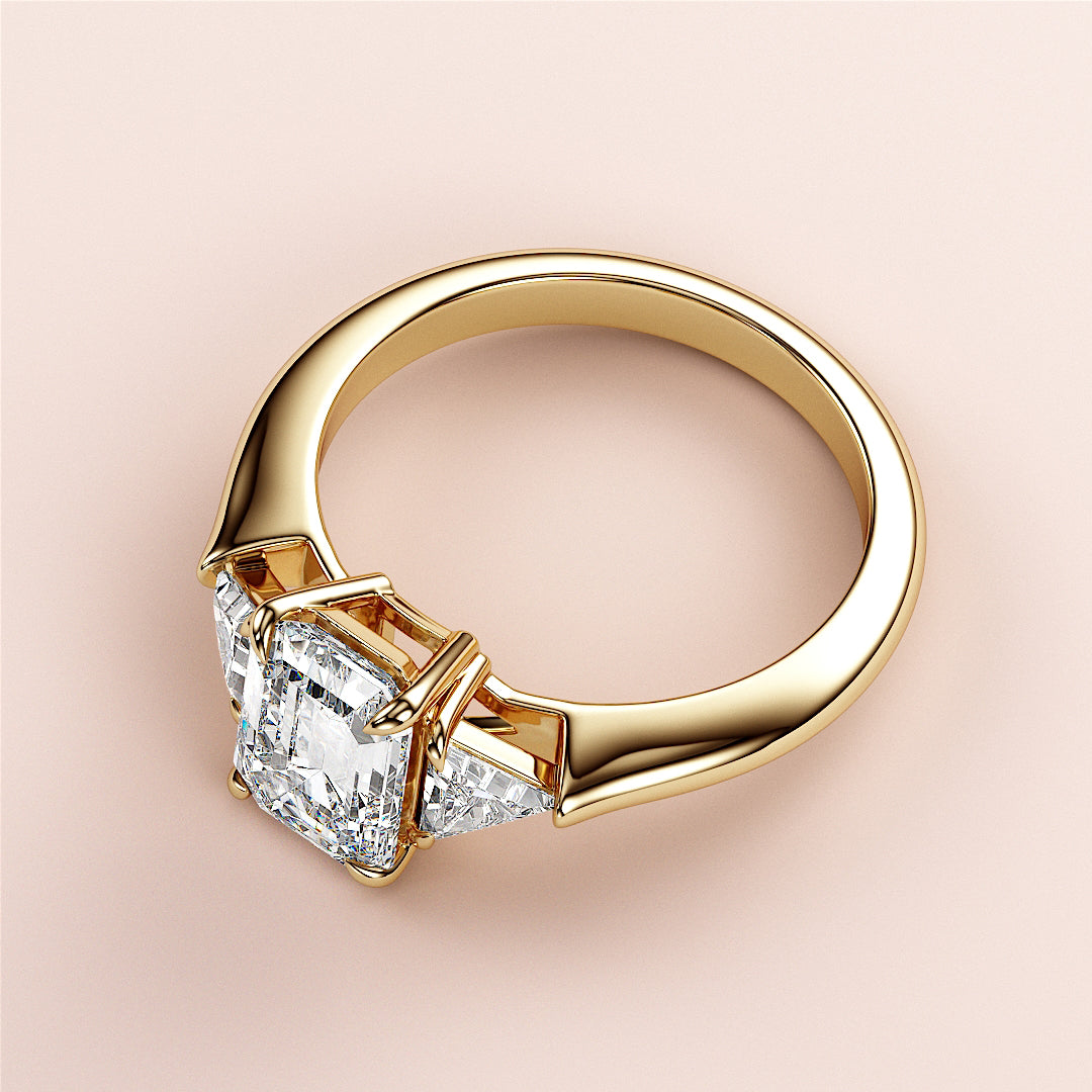 Elegant 14K/18K yellow gold engagement ring with emerald three-stone triangle design, perfect for a timeless love story.