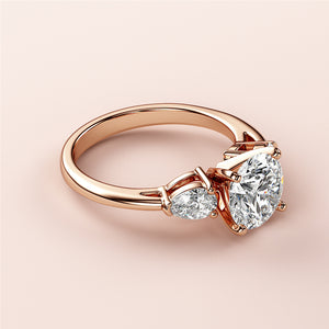 Elegant engagement ring featuring a pear-shaped diamond and round brilliant center diamond, available in 14K or 18K rose gold.
