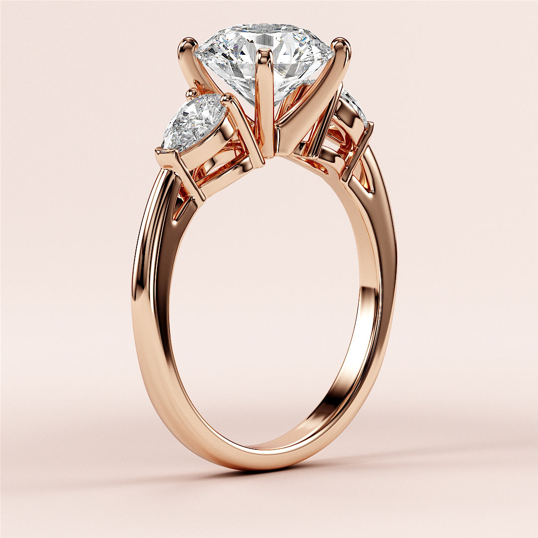 Elegant 14K/18K rose gold engagement ring with dazzling round-cut diamond and two side stones, showcasing timeless luxury.