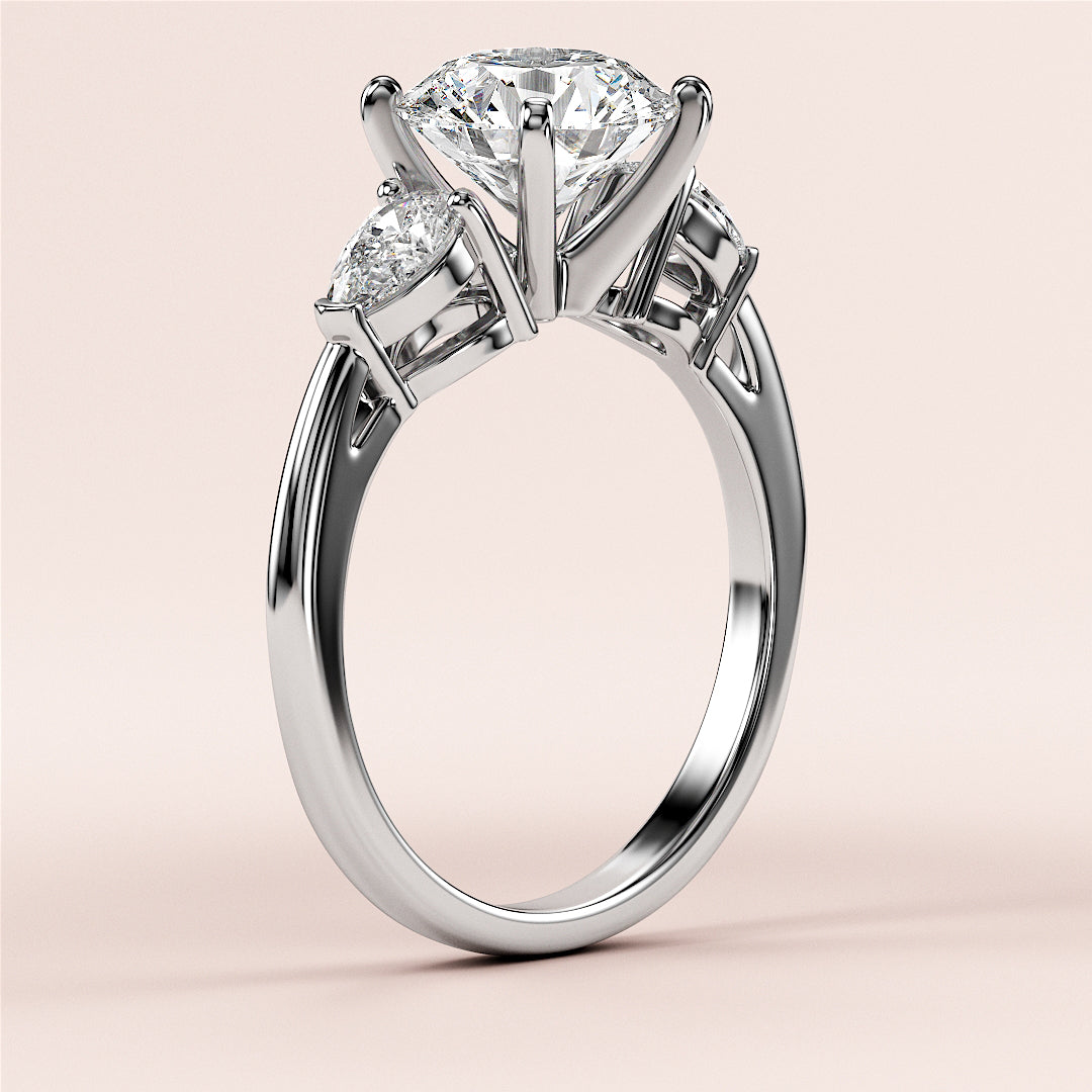 Elegant 14K white gold three-stone engagement ring with a round diamond center and side stones, perfect for a timeless proposal.