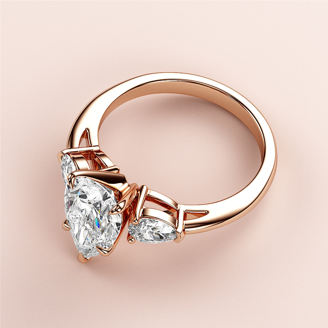 Elegant 14K Rose Gold pear-shaped diamond engagement ring with three stunning diamonds, perfect for proposing or celebrating love.