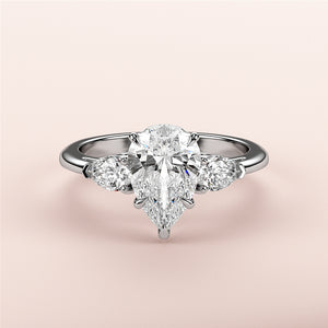 Elegant pear-shaped diamond engagement ring with side stones in 14K or 18K white gold or platinum, showcasing timeless beauty.