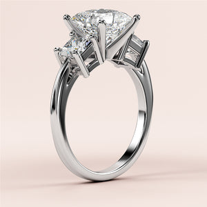 "Elegant 14K white gold three-stone engagement ring with pear-shaped diamond and two accent diamonds, perfect for timeless romance."