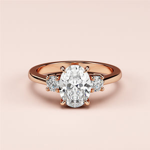 An elegant oval-shaped diamond engagement ring with side stones on a 14K or 18K rose gold or platinum band.