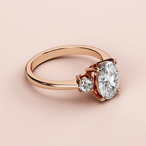 Elegant rose gold engagement ring with oval and round diamonds, available in 14K, 18K gold, or platinum. Timeless design.