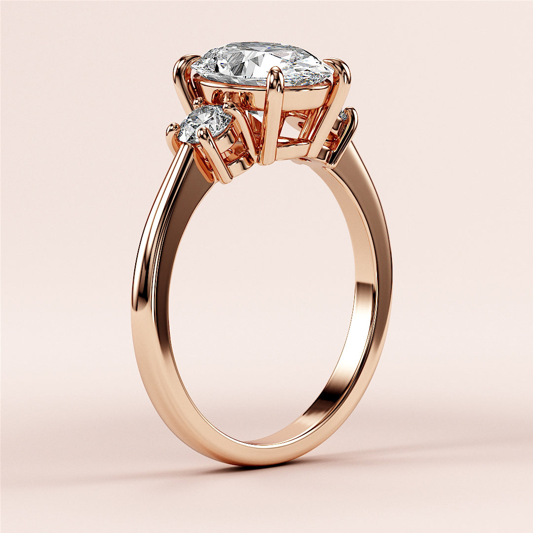 Beautiful rose gold engagement ring featuring an oval-cut diamond and two round accent diamonds, crafted in 14K or 18K gold and platinum.|







#14KRecycledRoseGold
#18KRecycledRoseGold


