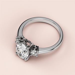 Elegant 14K/18K white gold engagement ring with a round diamond center and two smaller round diamonds, exuding sparkle and sophistication.