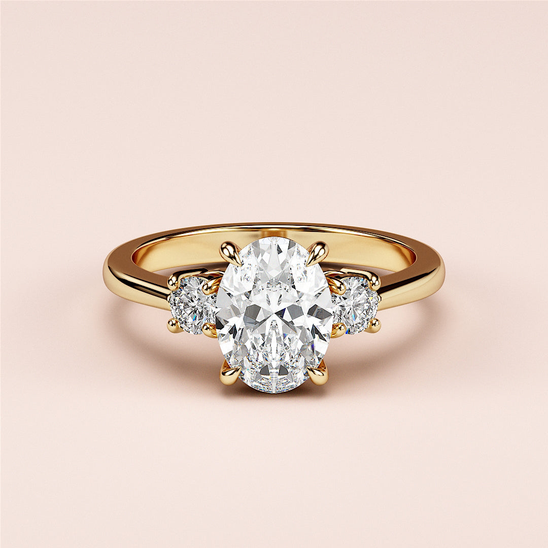 Oval-shaped engagement ring featuring two round side stones, set in 14K or 18K yellow gold or platinum band.|




#14KRecycledYellowGold
#18KRecycledYellowGold






