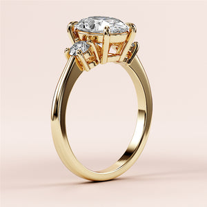 Elegant 14K and 18K yellow gold engagement ring featuring marquise-cut and round-cut diamonds, shown in close-up.
