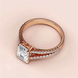 Elegant emerald-cut diamond engagement ring in rose gold, featuring a split shank and pave band, available in 14K & 18K gold or platinum.