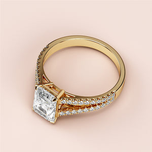 Elegant 14K gold radiant-cut diamond engagement ring in a pave band, featuring sparkling side stones for added brilliance.