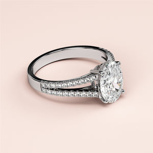 Elegant 14K or 18K gold or platinum engagement ring with oval diamond and split shank, adorned with petite diamonds for timeless brilliance.