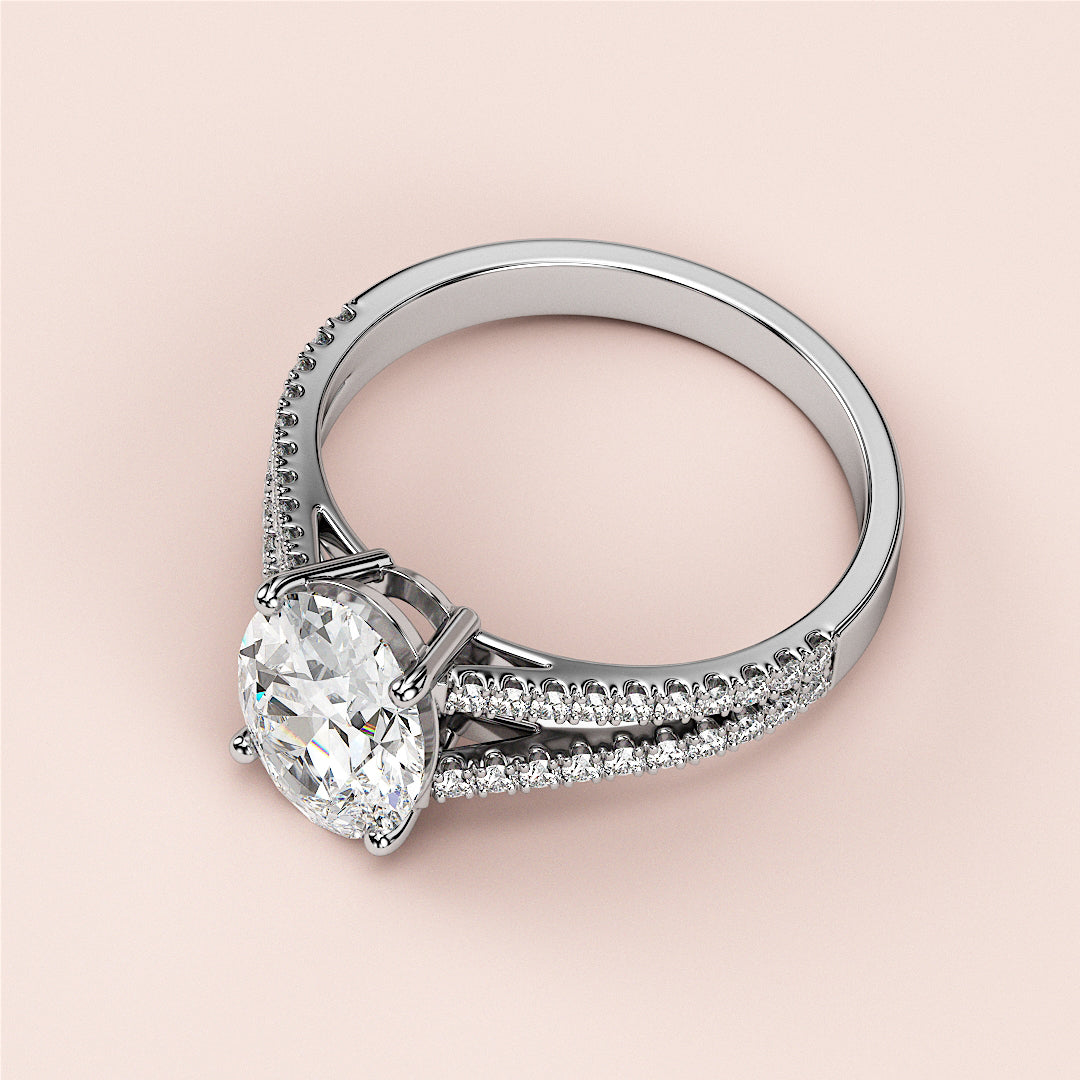 Elegant 14K or 18K white gold engagement ring with an oval-cut diamond center and pave accents, set against a soft background.|

#14KRecycledWhiteGold
#18KRecycledWhiteGold








#Platinum