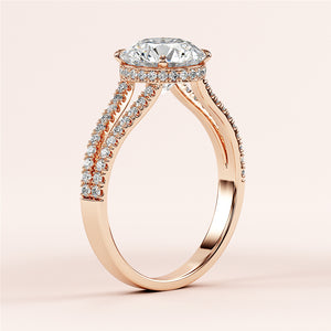 Elegant rose gold engagement ring featuring a cushion-cut diamond, halo of round diamonds, and pave-set split shank band. Available in 14K and 18K.
