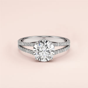 Elegant 14K/18K white gold engagement ring with round brilliant cut, split shank band, andPave diamonds. Perfect for your proposal!