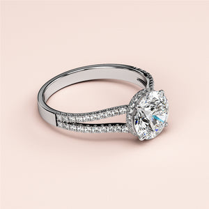 Elegant 14K/18K white gold engagement ring with round brilliant-cut diamond in a split shank band, worn on model's hand.