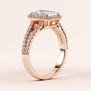 Elegant 14K or 18K rose gold engagement ring featuring a radiant halo, split shank, and emerald-cut diamond centerpiece.