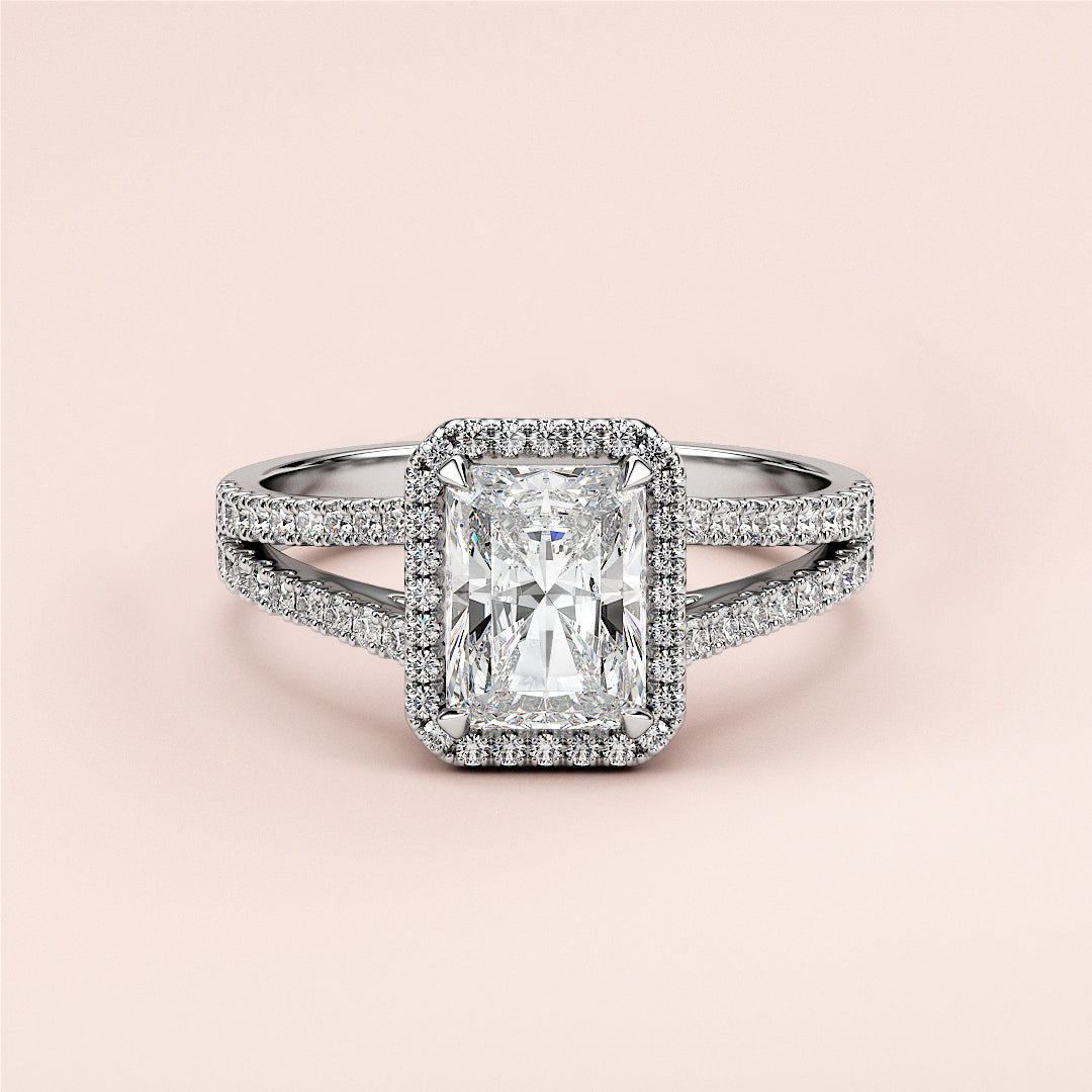Radiant cut diamond engagement ring with split shank and halo setting, available in 14K and 18K gold or platinum.