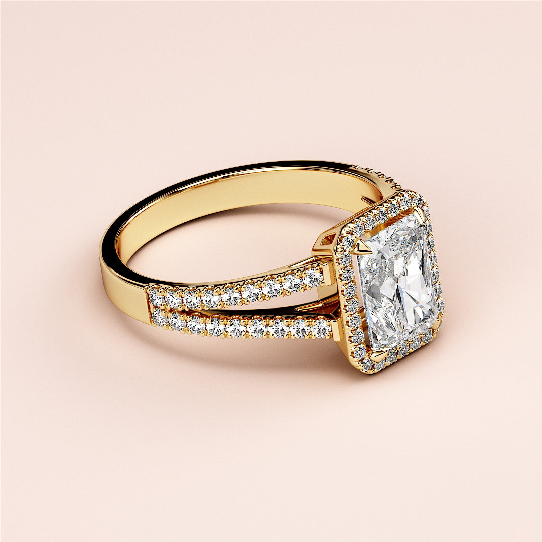 Engagement ring with radiant-cut diamond in halo setting, crafted in 14K or 18K gold or platinum, featuring pave diamonds on split shank.