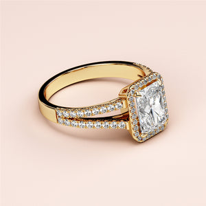 Engagement ring with radiant-cut diamond in halo setting, crafted in 14K or 18K gold or platinum, featuring pave diamonds on split shank.