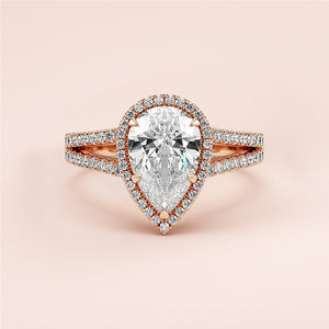 Elegant 14K or 18K rose gold pear-shaped diamond engagement ring with split shank and pave band, featuring dazzling accents.