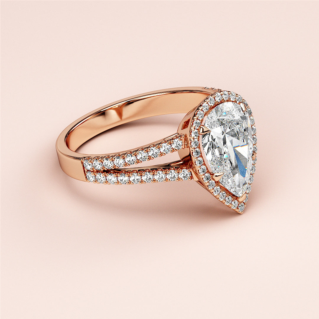 Rose gold engagement ring with pear-shaped diamond halo, split shank adorned with diamonds, available in 14K, 18K, or platinum.|







#14KRecycledRoseGold
#18KRecycledRoseGold


