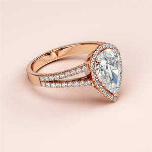 Rose gold engagement ring with pear-shaped diamond halo, split shank adorned with diamonds, available in 14K, 18K, or platinum.
