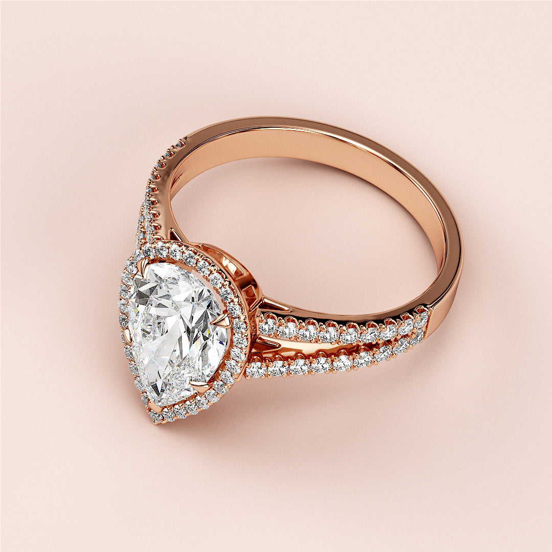Rose gold engagement ring with pear-shaped diamond center, halo of smaller diamonds, available in 14K, 18K, or platinum.|







#14KRecycledRoseGold
#18KRecycledRoseGold


