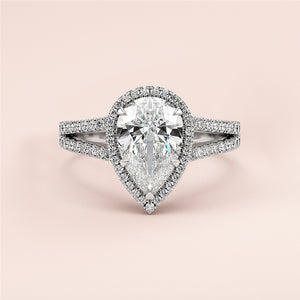 Exquisite 14K white gold pear-shaped diamond engagement ring with halo, split shank, and pave band. Perfect for your special moment.