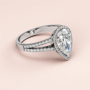 Luxurious pear-shaped diamond engagement ring in 14K/18K white gold, featuring intricate halo and split shank design.