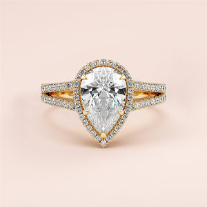 "Elegant 14K or 18K yellow gold pear-shaped engagement ring with diamond halo and split shank, perfect for forever."