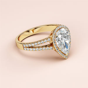 Elegant pear-shaped diamond engagement ring in 14K gold, featuring a halo, split shank design, and stunning centerpiece.