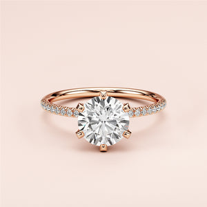 14K Rose Gold engagement ring featuring a round brilliant diamond andPave diamond band, elegantly displayed on a soft background.