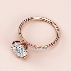 Elegant 14K rose gold engagement ring with round solitaire and accent diamonds, perfect for a timeless romantic proposal.