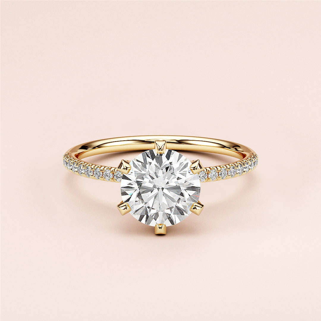 Elegant 14K yellow gold engagement ring with a round cut diamond center and pave diamond band, perfect for special occasions.