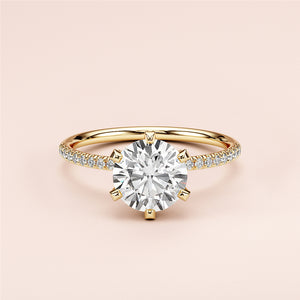 Elegant 14K yellow gold engagement ring with a round cut diamond center and pave diamond band, perfect for special occasions.