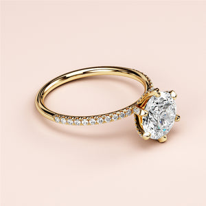 Elegant 14K gold engagement ring featuring a stunning round diamond with pave accents, perfect for your special moment.