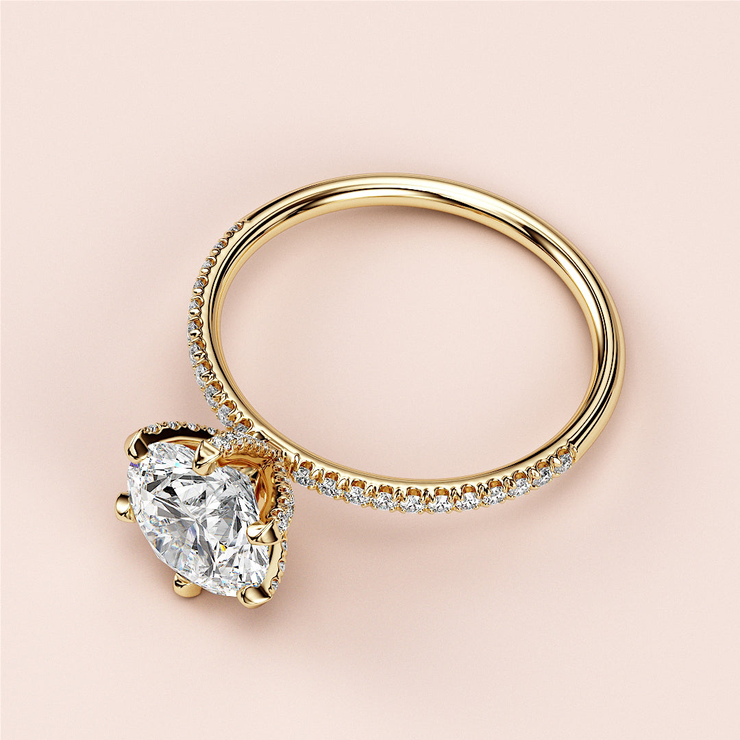 Heart-Shaped Diamond Engagement Ring in 14K or 18K Gold, featuring pave-set accents, elegant design against neutral backdrop.