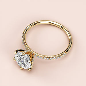 Heart-Shaped Diamond Engagement Ring in 14K or 18K Gold, featuring pave-set accents, elegant design against neutral backdrop.
