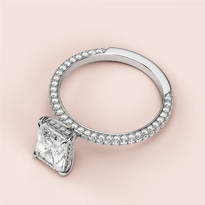 Elegant 14K/18K white gold engagement ring with princess cut diamond andPave-set diamond band, perfect for unforgettable moments.