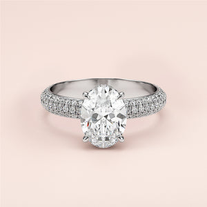 Elegant oval cut diamond engagement ring in white gold, featuring a multi-rowPave band and hidden halo accents. Not worn on model.