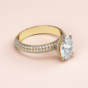 Elegant oval-cut diamond engagement ring in 14K yellow gold setting withPave accents and hidden halo design.